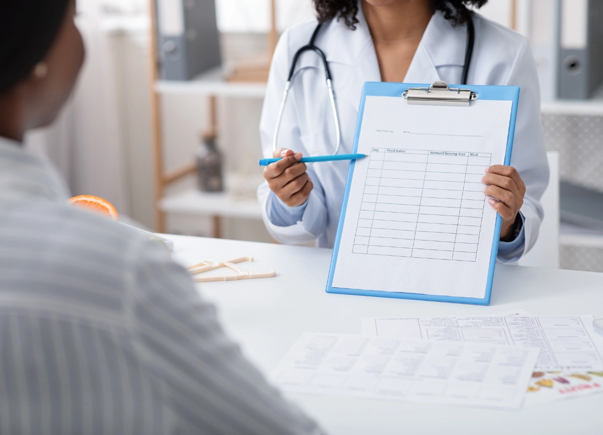 A picture of a clipboard with a doctor showing a pen for a consultation