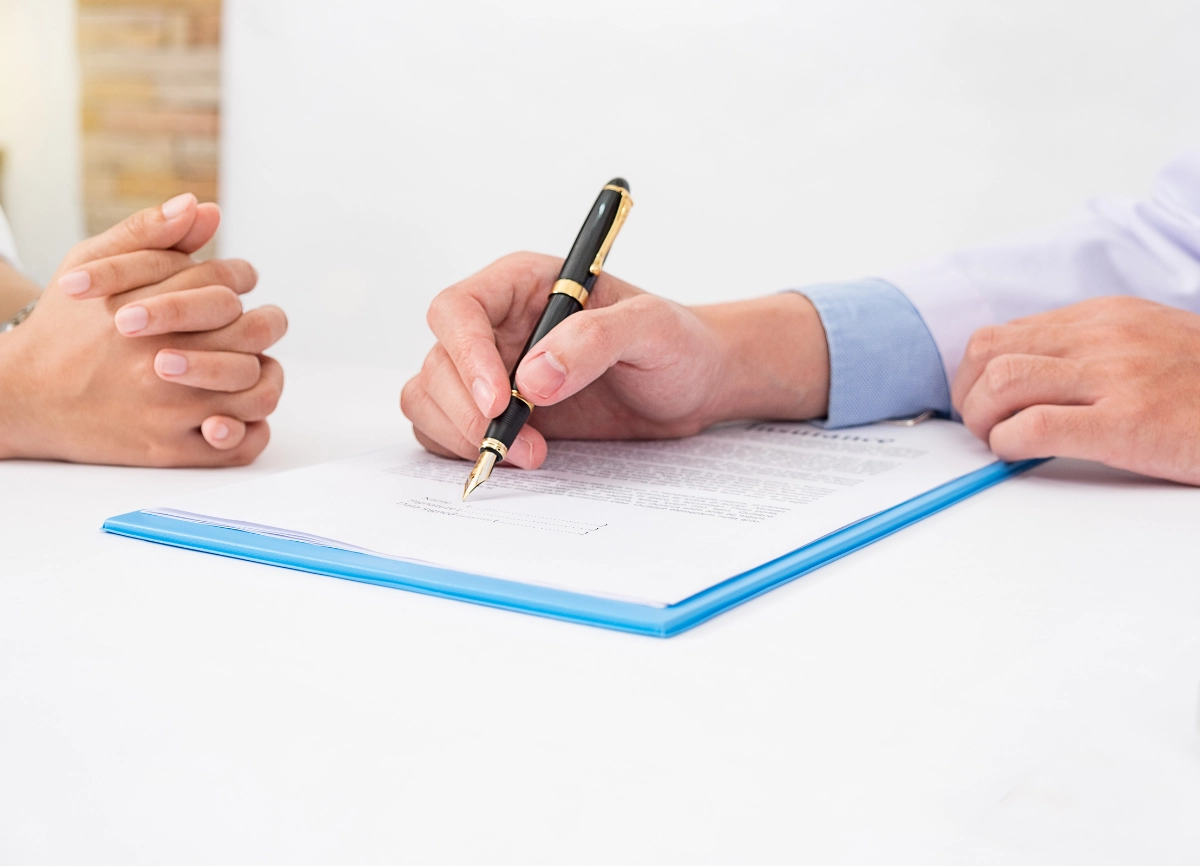 A picture of a and filling in a document as part of a hair loss consultation