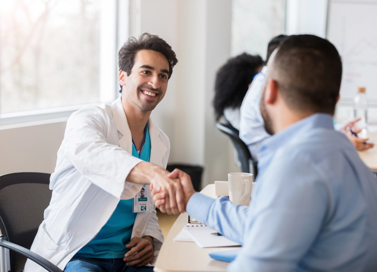 A picture of a man shaking hands with a doctor after a consultation for PRP treatment